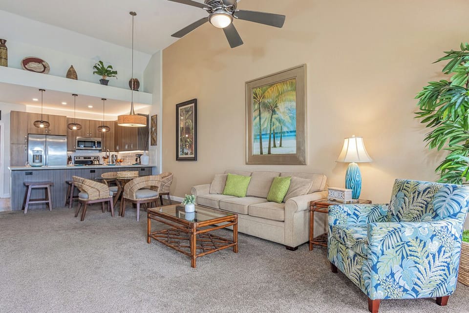 Bright and comfortable living space with vaulted ceilings and island décor