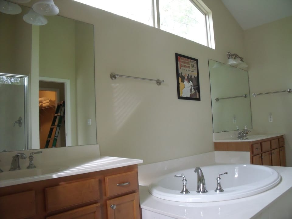 Master bathroom with dual sinks and oversized tub