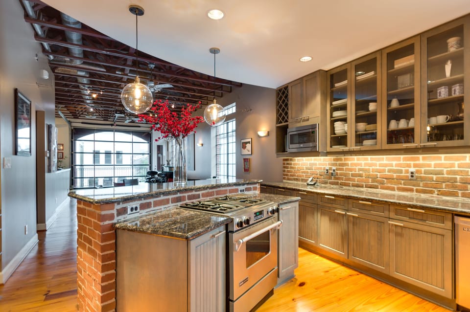 very spacious kitchen with lots of storage cabinets.