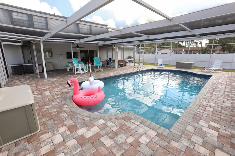 Enjoy the large heated pool, hot tub, grill, and covered patio.