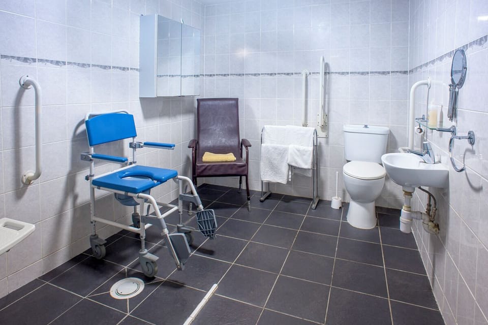 Full disabled wet room. Commode/shower chair fits over toilet if required