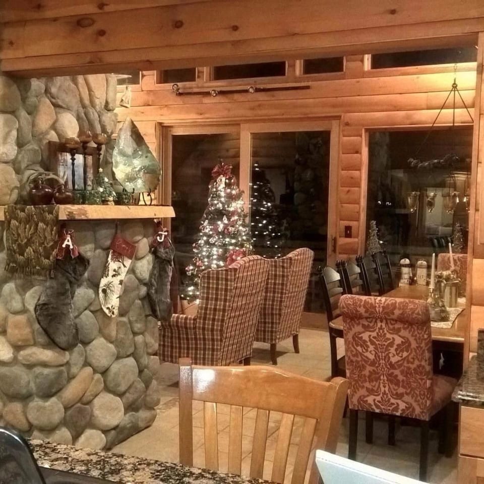 View form kitchen into great room with walk around fireplace and woodstove