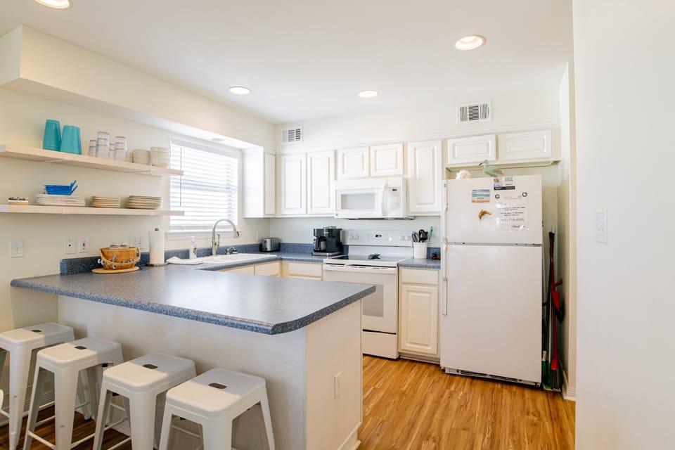 The stocked kitchen has fridge with icemaker, smoothtop stove/oven, microwave...