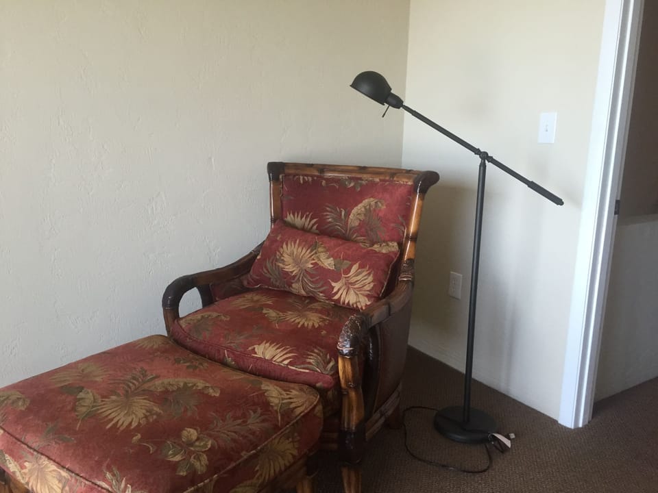 Master bedroom chair faces patio door.