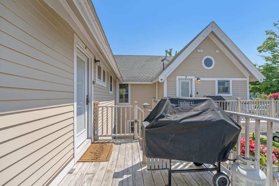 A Weber propane BBQ with utensils provided at the Michiana Apartment #4.