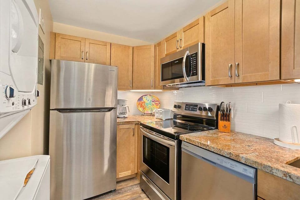 A modern kitchen with stainless appliances and granite counters, ready for island‑style cooking.