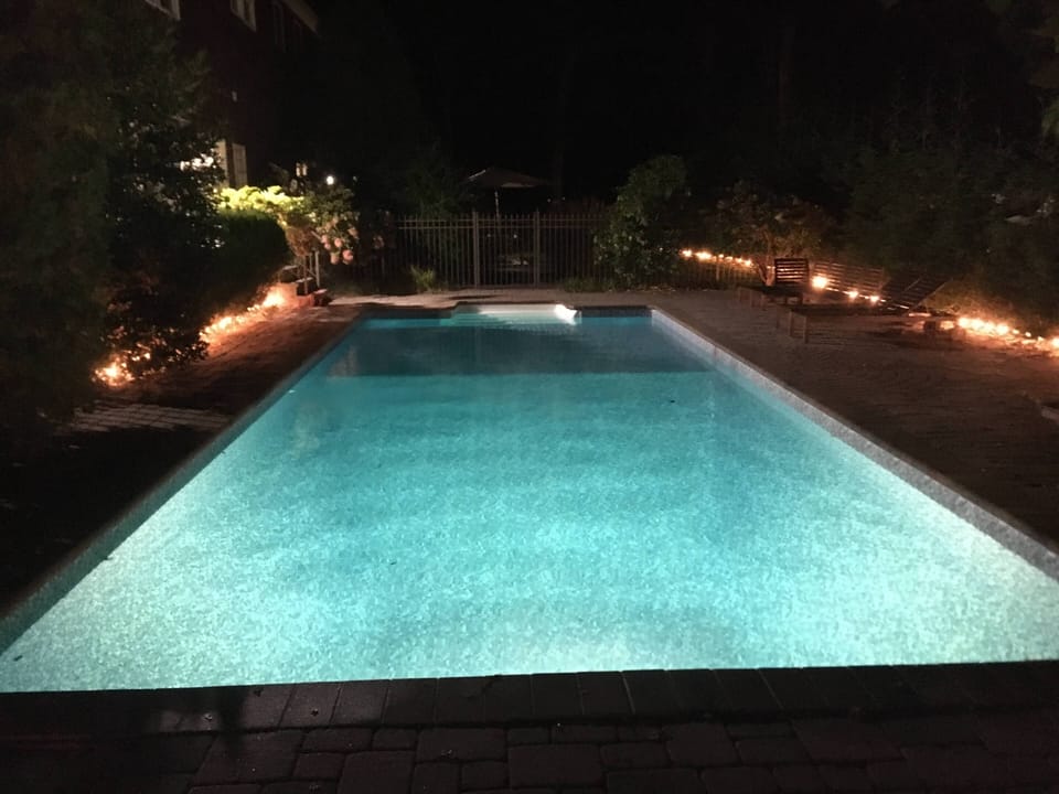 Pool, deck and rear yard are lit for evening use.