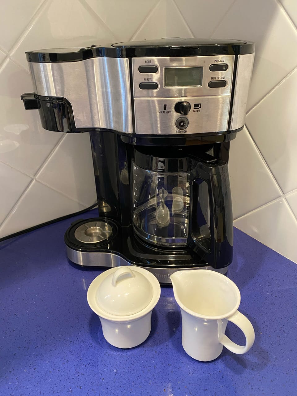 Coffeemaker makes single cup or pot and has reusable filters 