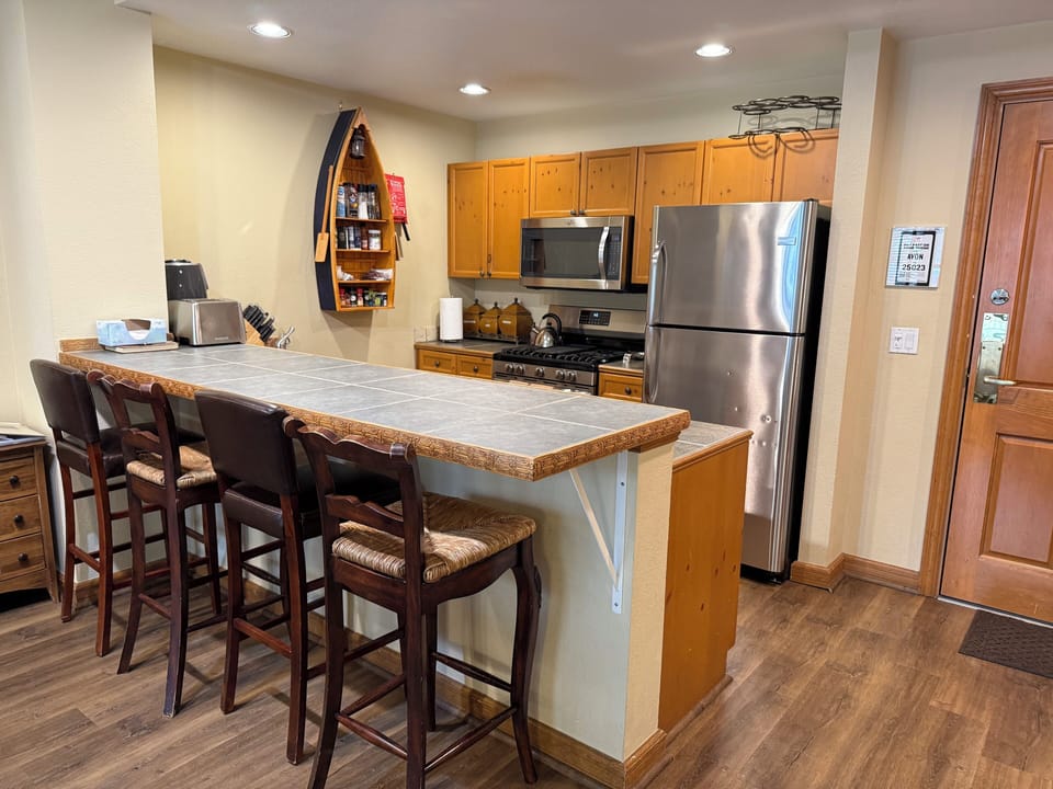 The kitchen has stainless steel appliances, all sorts of gadgets, coffee/creamer