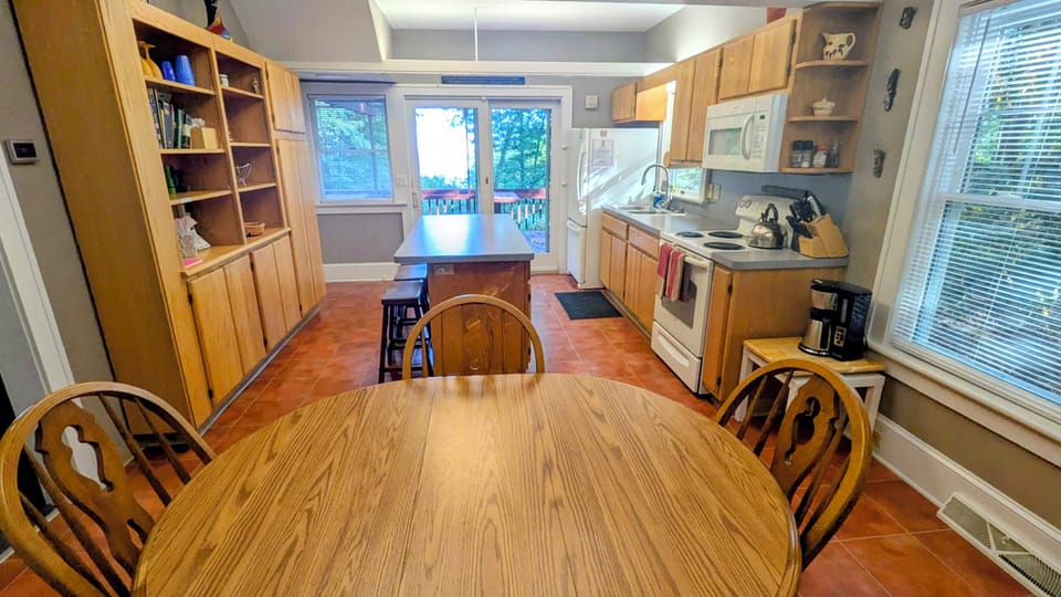 Seats 4 can expand to seat 6 (leaf under sofa in living room)