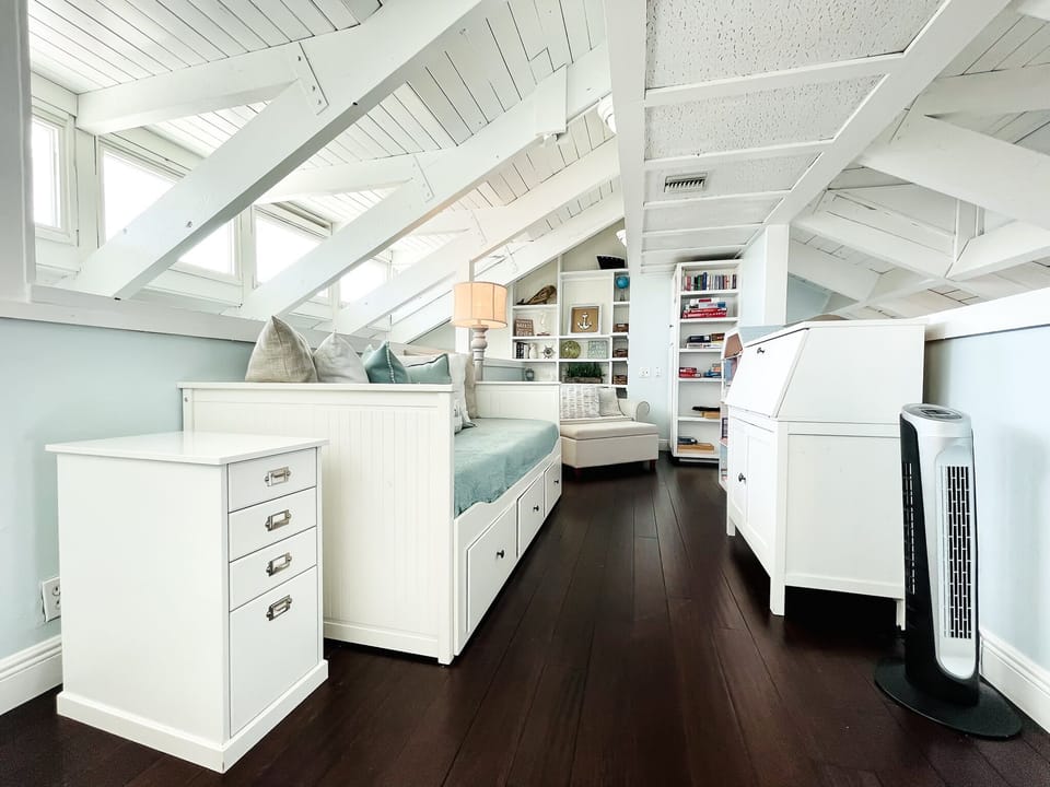 Loft area equipped with games,  dollhouse, pullout chair and twin trundle.