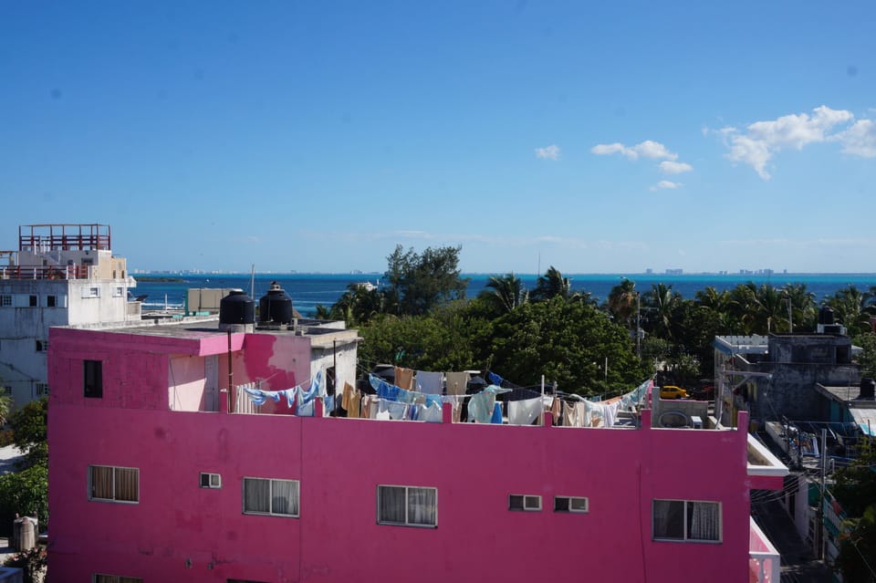 View from roof of colorful Isla Mujeres homes and beautiful Caribbean waters. 