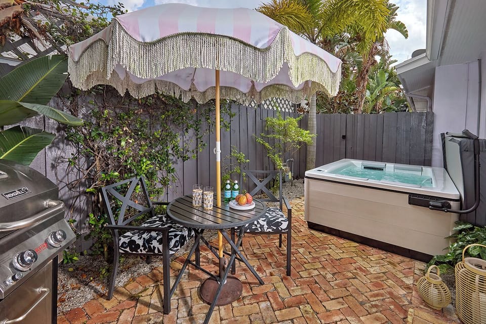 Enjoy the outdoors on a private patio featuring a custom spa, Cafe Table, & BBQ.