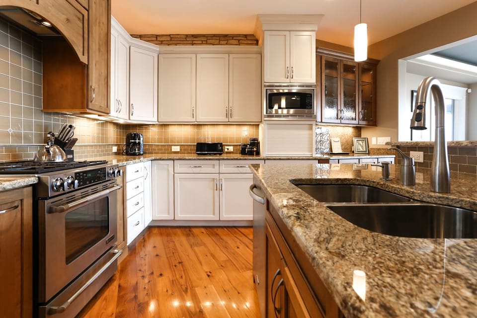 Main level kitchen with gas stove top, oven, microwave and dishwasher. 