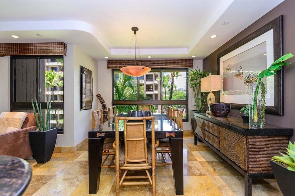 Stylish dining area with seating for six and tropical décor.
