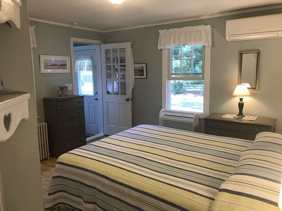 Bedroom #3 - view of queen bed, door goes out to sunroom w/ alternate entrance
