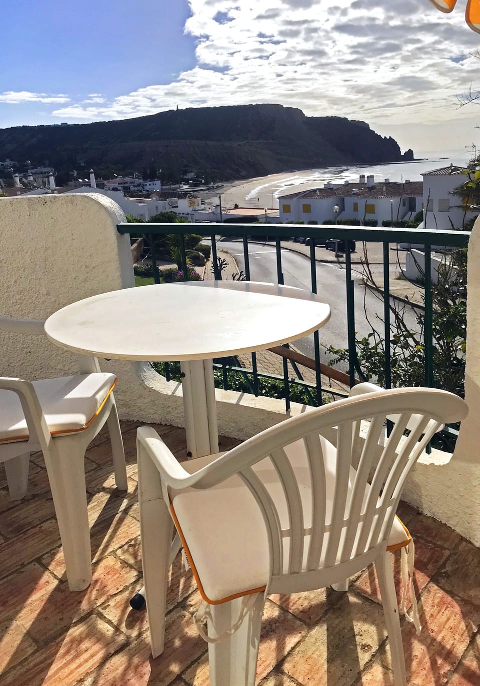 View from the balcony: beach, sea and Rocha Negra at the horizon.