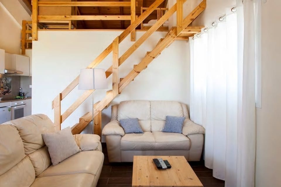 Family Apartment, 2 Bedrooms, Pool View | Living area | 43-inch flat-screen TV with premium channels, TV, books