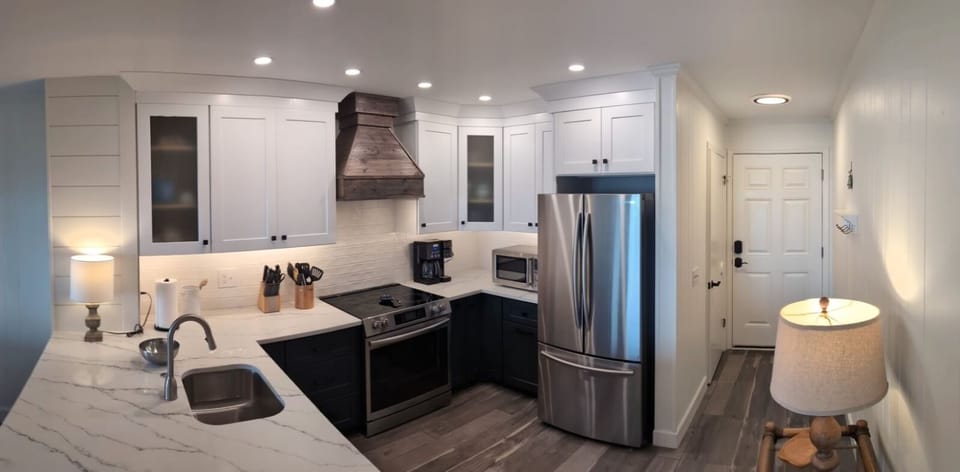 Pano view of kitchen and entry from living area.
