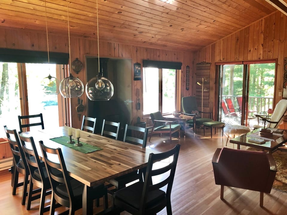 Dining area / Living room with a warm wood feel and lots of views of the lake