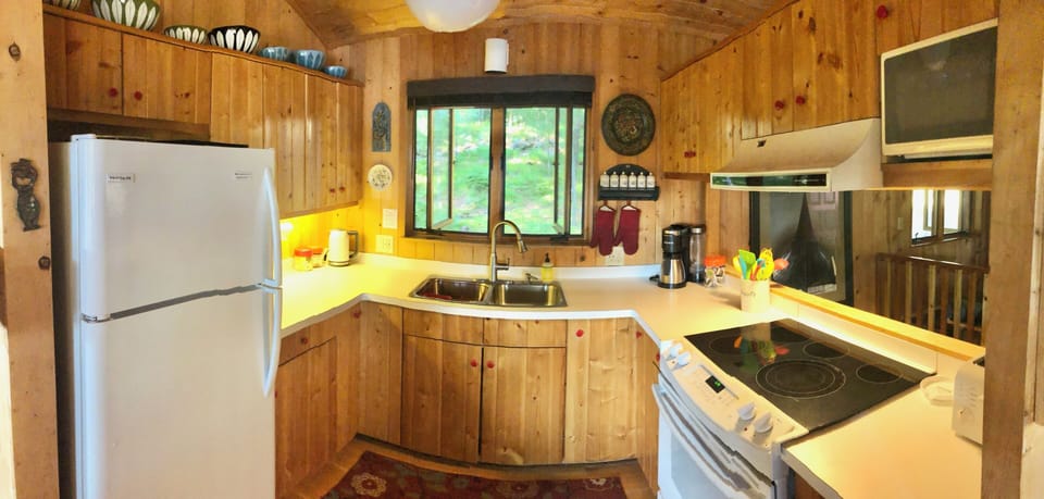 Fully stocked kitchen with views of the lake while cooking