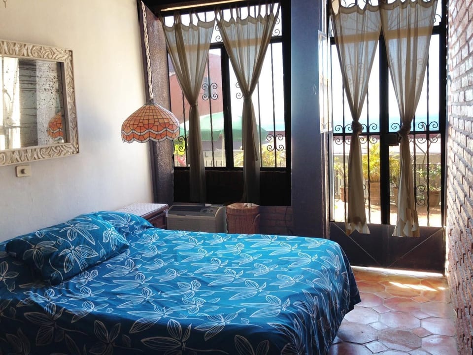 Second bedroom with A/C and double bed. French doors to patio and pool 