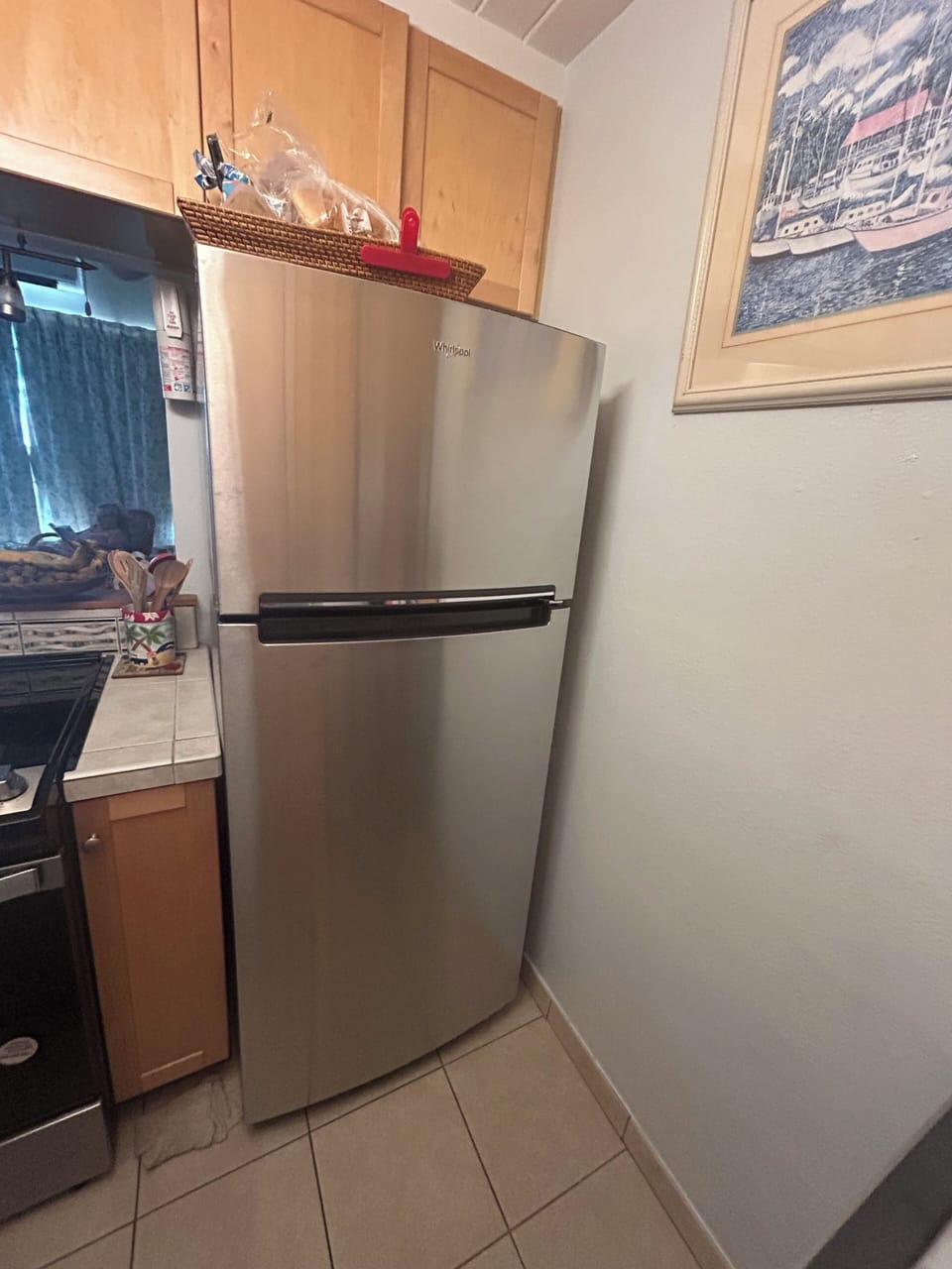 Kitchen- New Whirlpool Refrigerator with an ice maker.