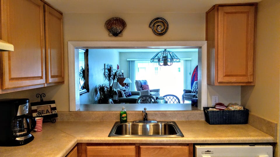 Kitchen area looking into living area and balcony