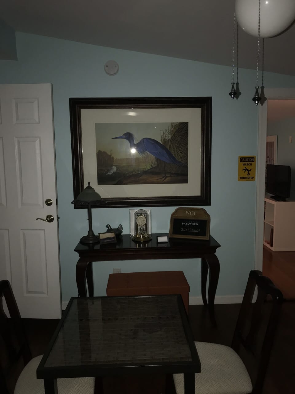 Living room equipped with a large TV, stereo and Alexa.
