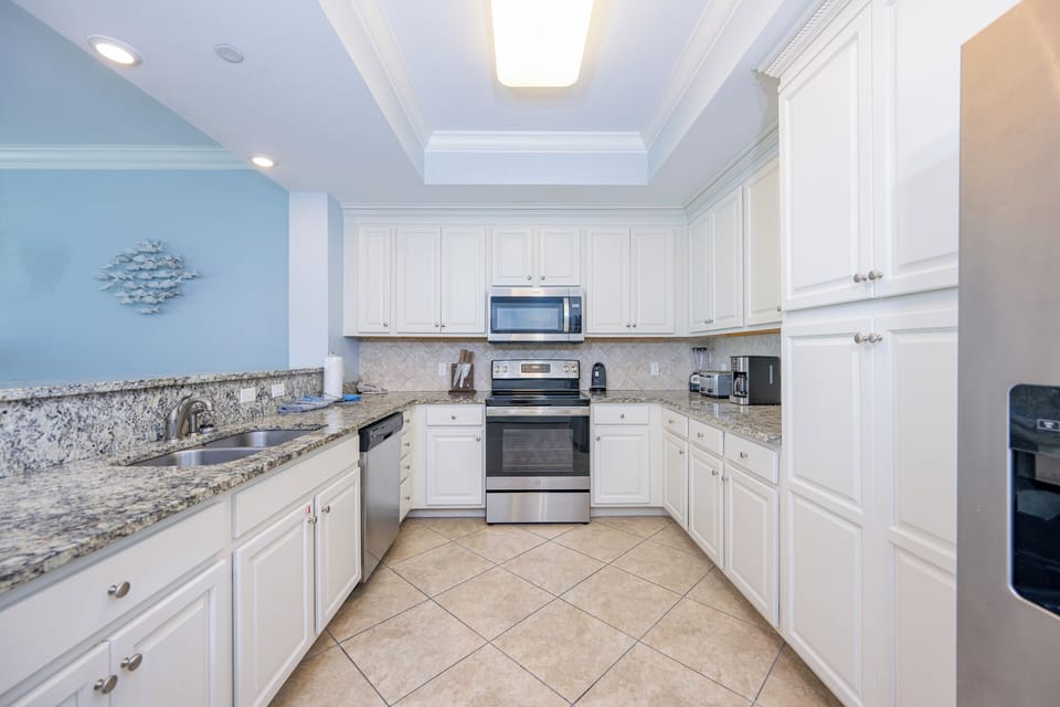 White cabinets shine under soft light as you prepare fresh meals and gather around the breakfast bar in the kitchen