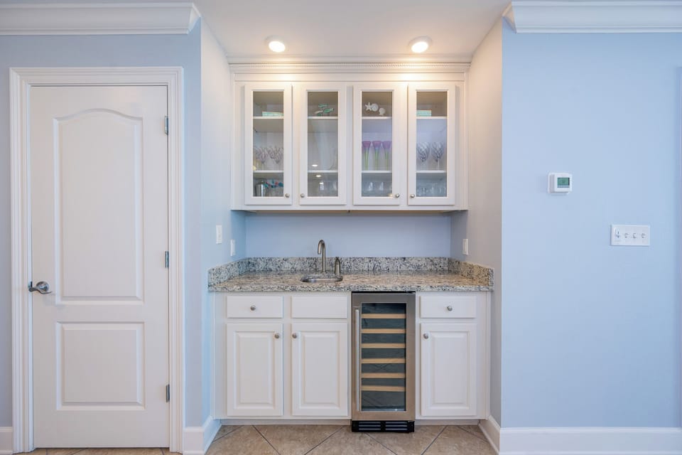 A wet bar with granite counters and a wine cooler awaits your favorite drinks while you unwind