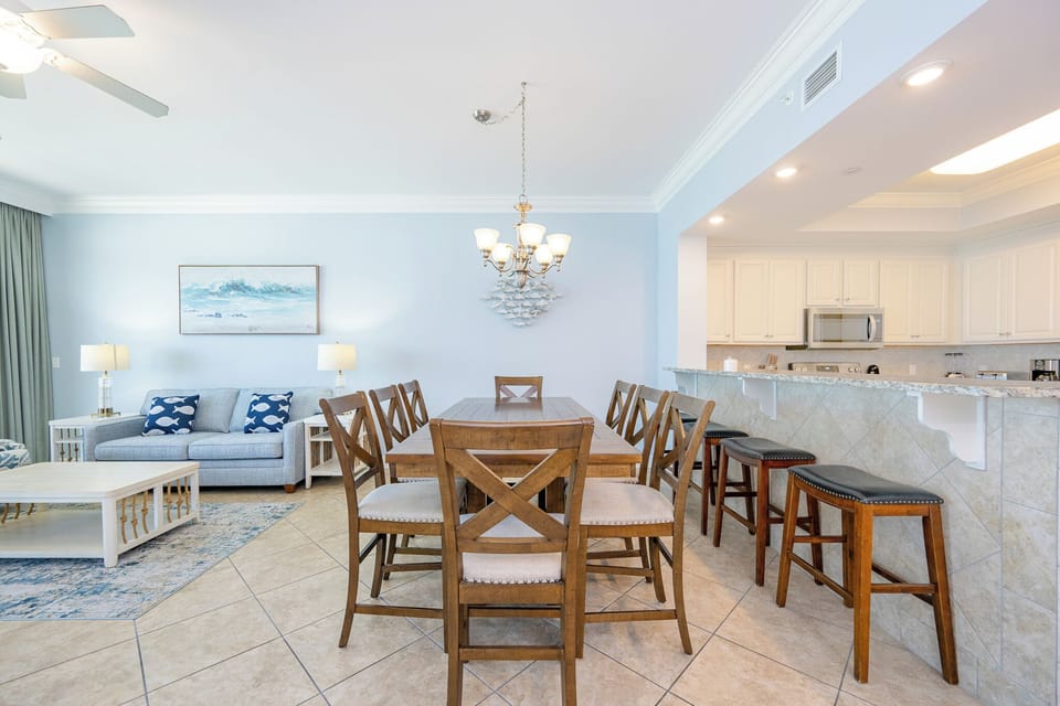 Gather around the dining table to share laughter and stories after a day of beachside fun in the living room