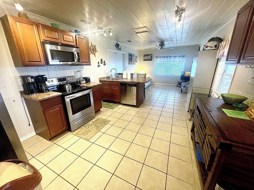 Fully stocked kitchen with coffee pot, blender, and new 2024 pots and pans. 