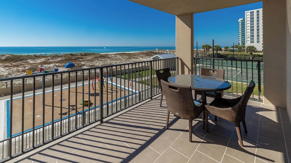 Enjoy meals or drinks at the outdoor table while taking in the scenic views of the beach, pool area, and splash park