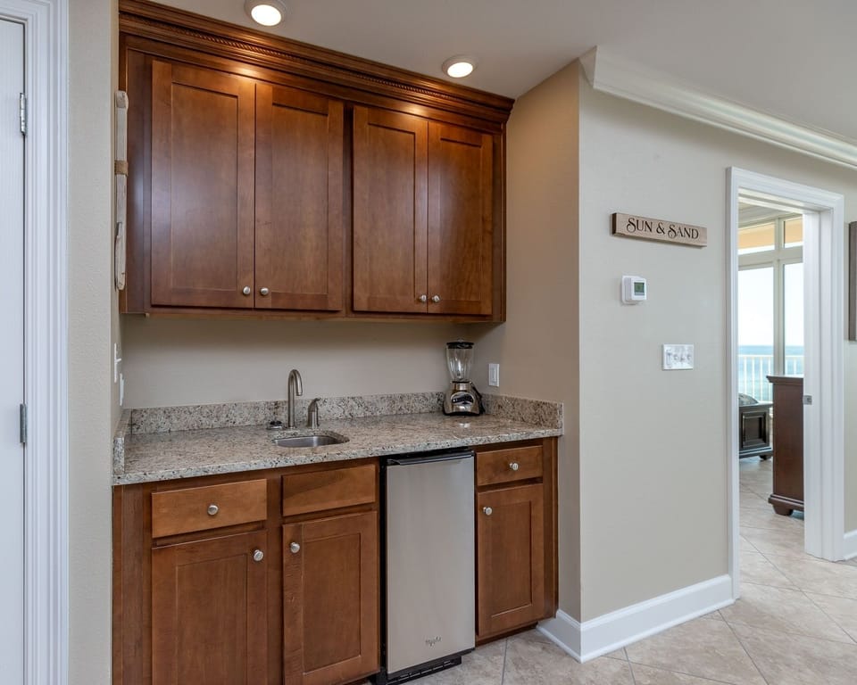 Grab a chilled drink from the fridge or create your favorite cocktail at the wet bar with elegant glassware displays