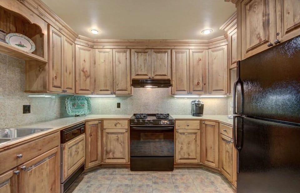 Rustic kitchen with rich wood cabinetry and warm lighting for a cozy cooking experience.