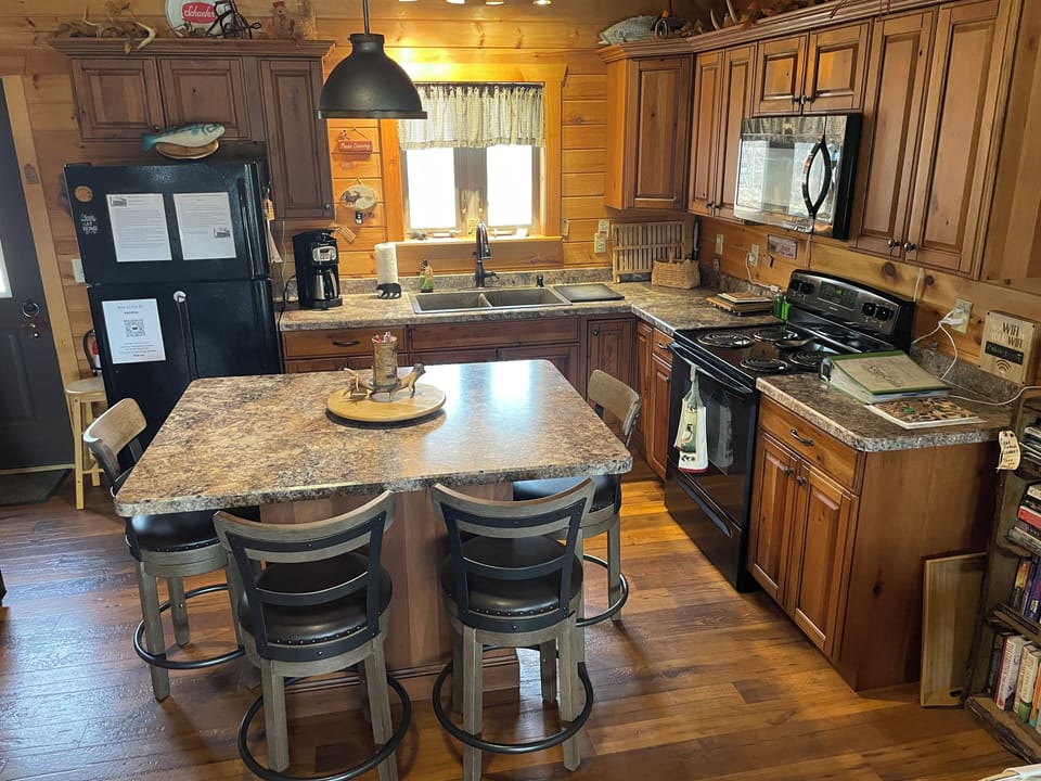 Comfortable swivel stools surround the kitchen island.