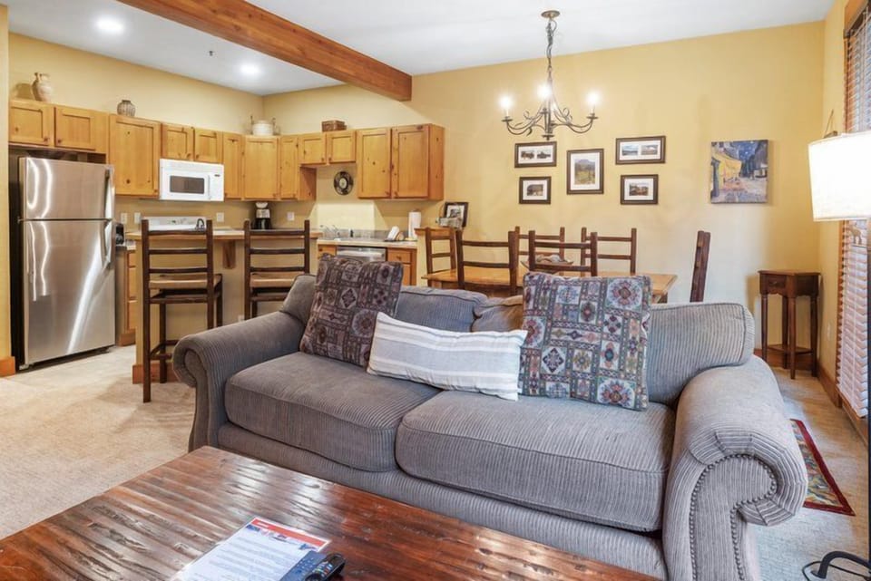 A cozy living room view showcasing an inviting couch and dining area, perfectly blending comfort and functionality.