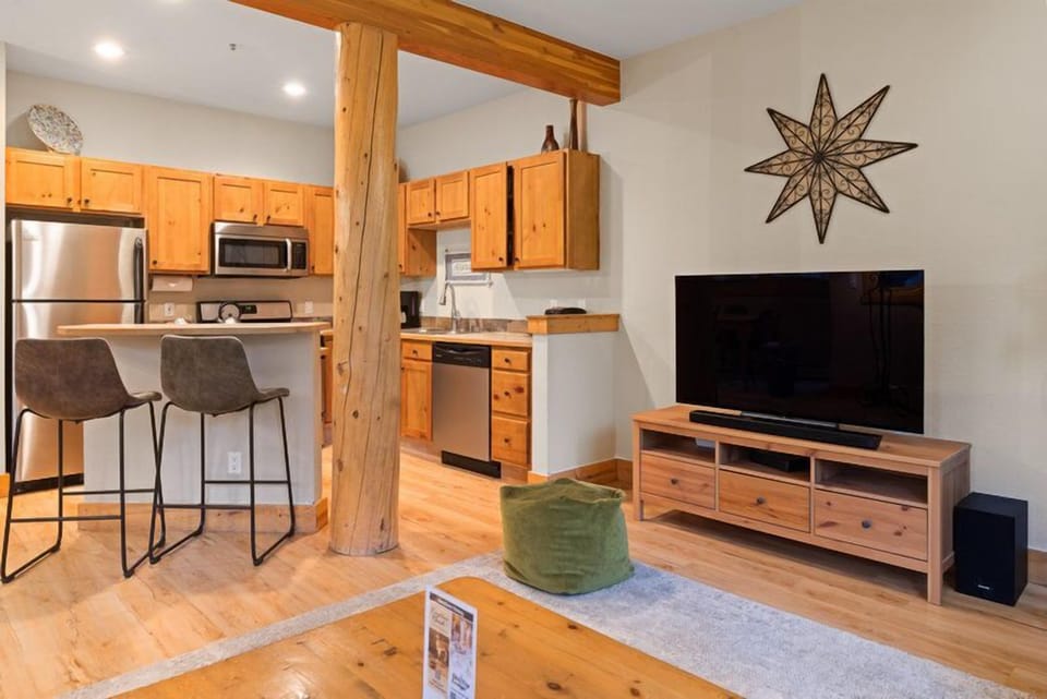 This inviting kitchen features rustic wooden cabinetry paired with modern appliances, creating a warm and functional space perfect for meal prep.