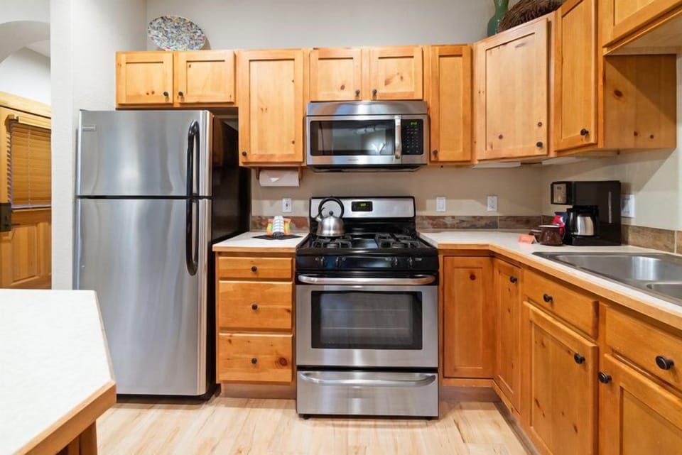 Designed for convenience, this kitchen includes stainless steel appliances and ample counter space, blending modern functionality with rustic charm.