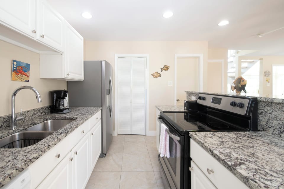 Kitchen with coffee maker, microwave, blender, all cooking tools. 