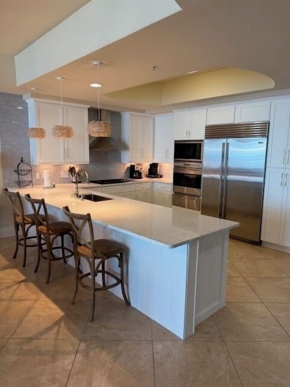 Beautiful updated white kitchen with white granite countertops
