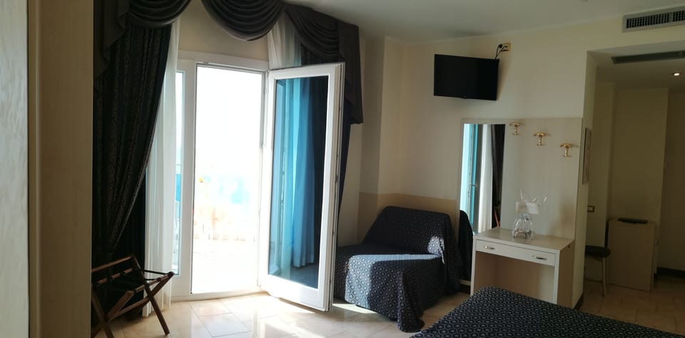 Triple Room, Balcony, Sea View | Minibar, in-room safe, cribs/infant beds, bed sheets