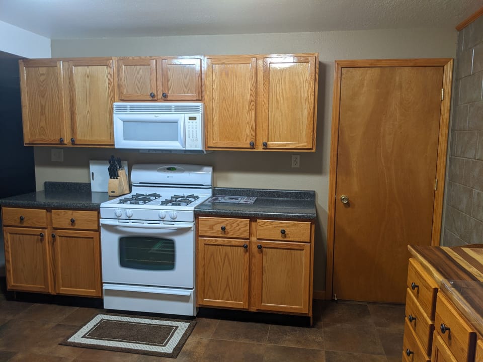 Full size stove/microwave with lots of staple items