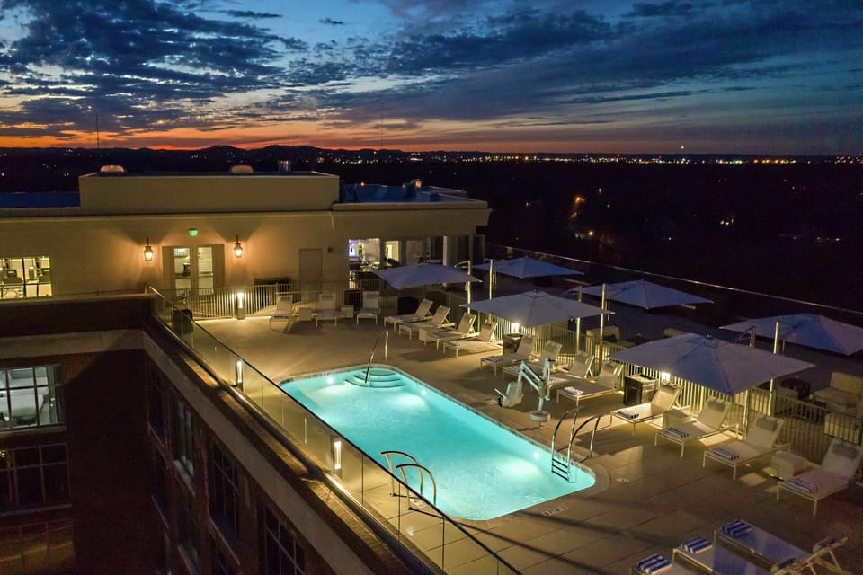 Seasonal outdoor pool, open 8:00 AM to 10:00 PM, pool umbrellas