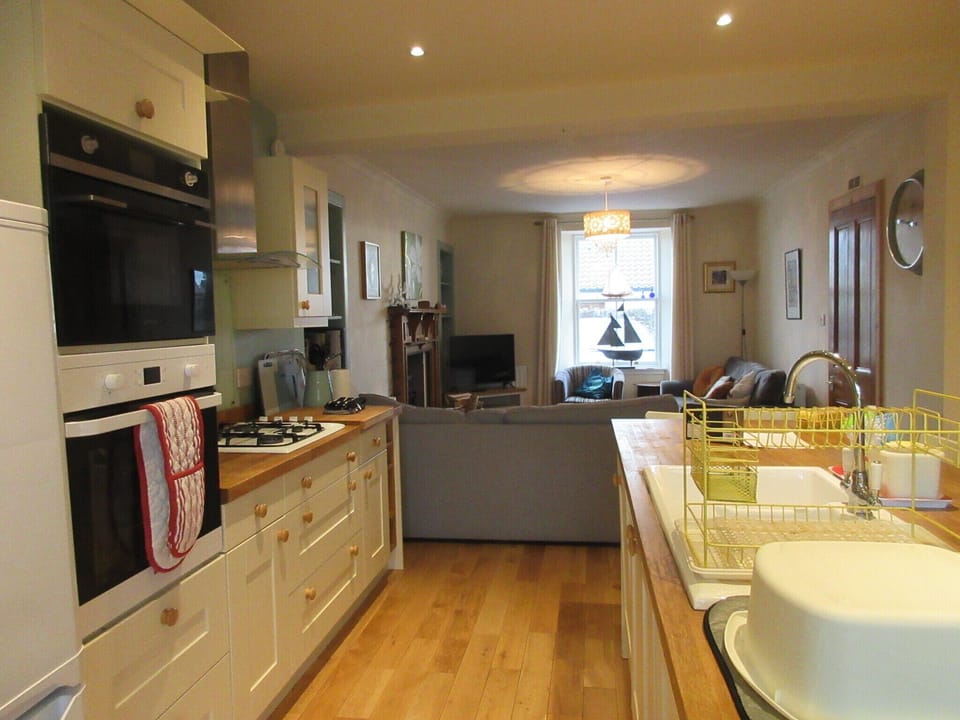 Kitchen looking over to living room