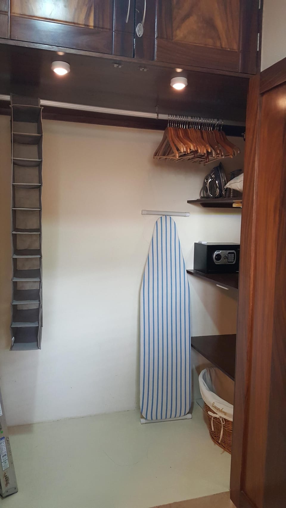 Master closet with iron, shoe holder, safe, hamper, shelves, and lots of hangers