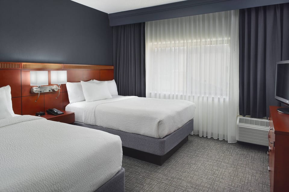 Premium bedding, desk, laptop workspace, iron/ironing board