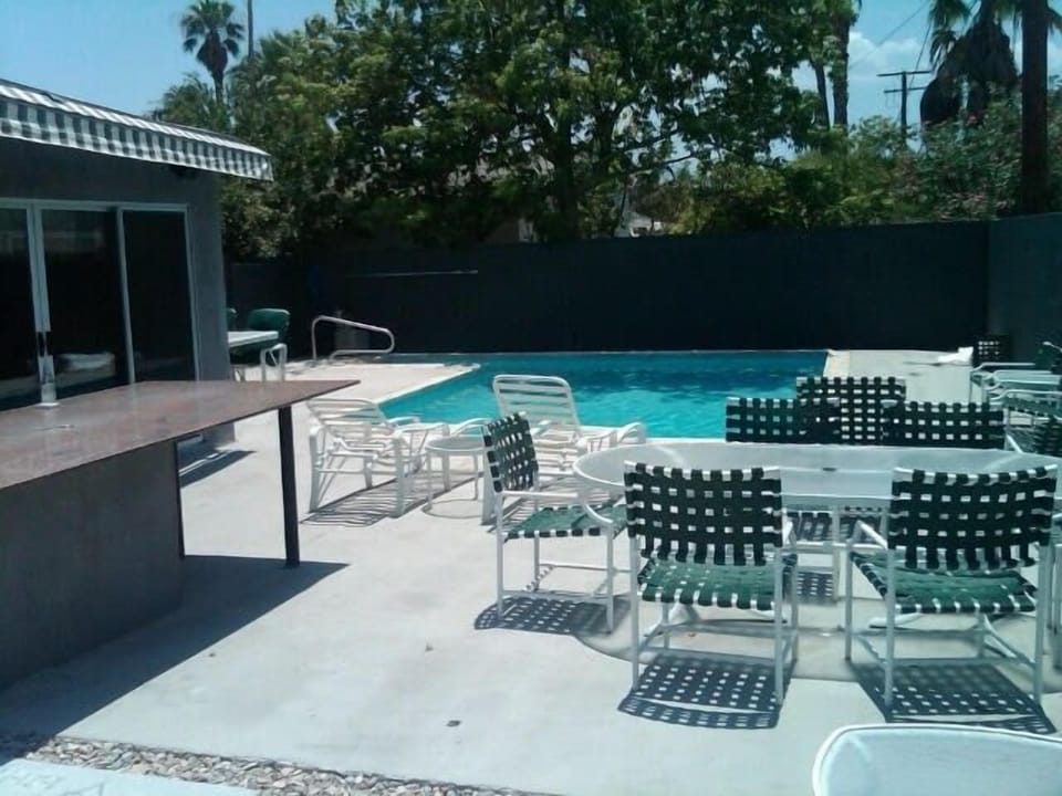 Spacious backyard/pool area with 2 beautiful grey and white awnings. 