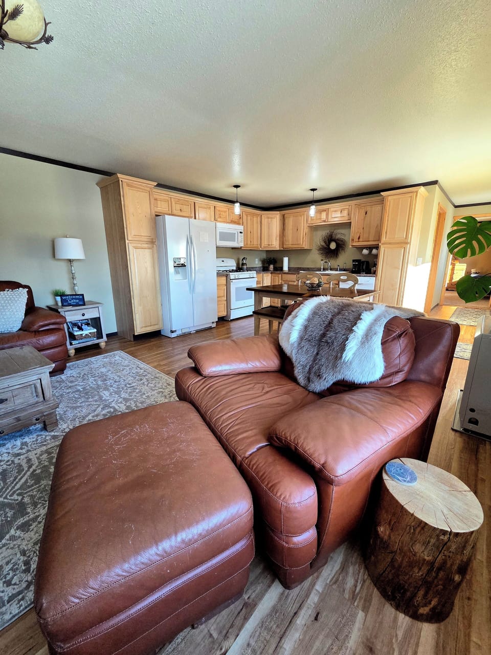 Cozy leather seating area by large picture window to enjoy the view or watch tv.